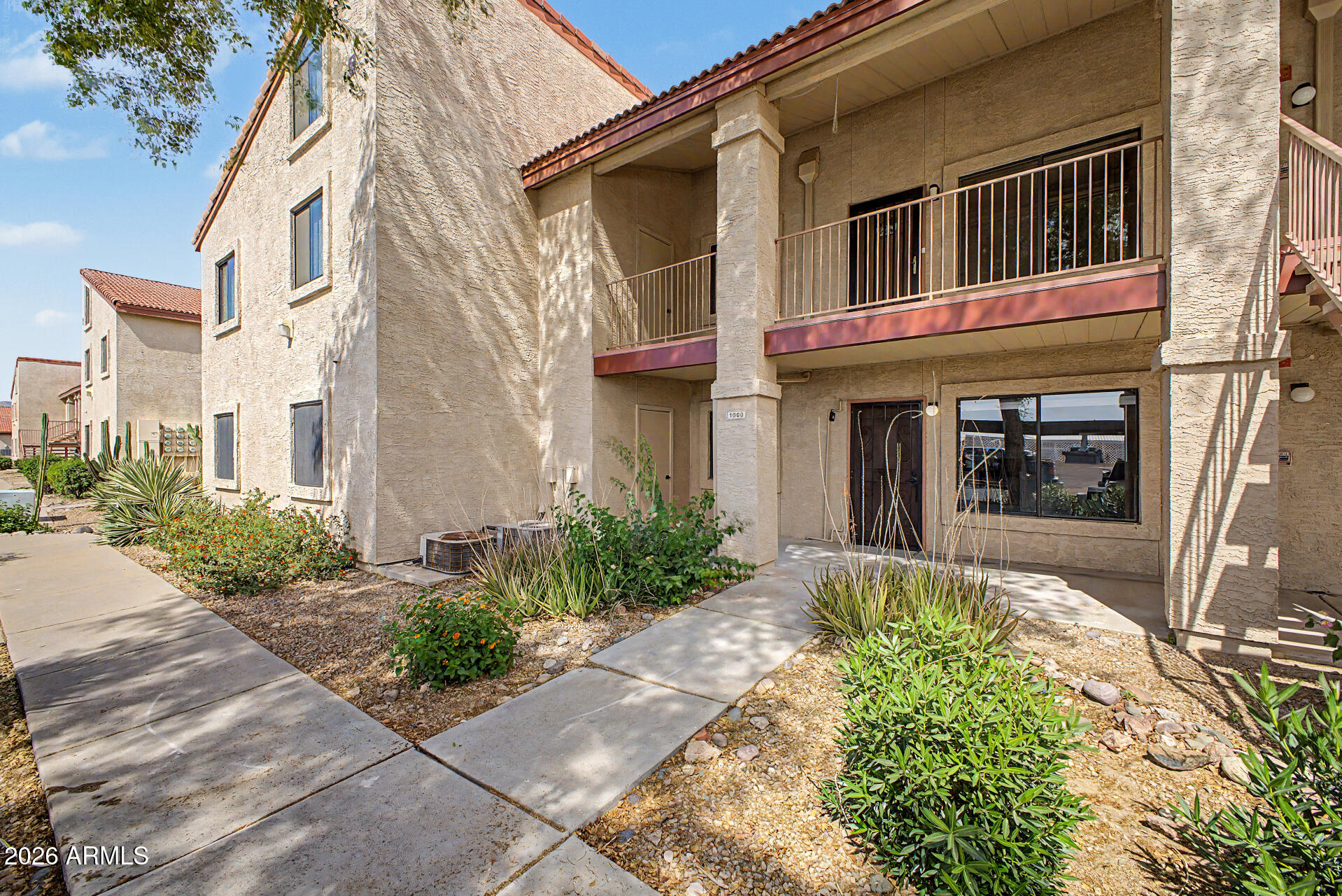 1440 North Idaho Road, Unit 1060 Apache Junction, AZ 85119 - Photo 5 of 16 a front view of a house with garden