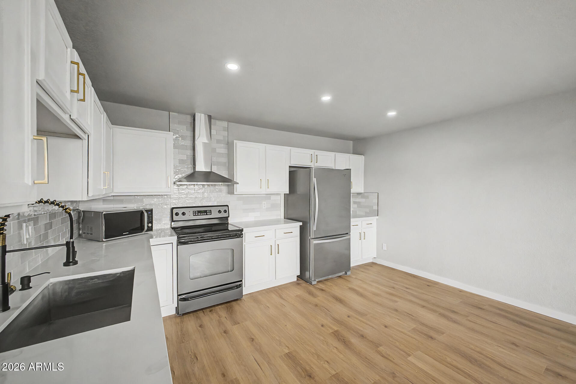 1440 North Idaho Road, Unit 1060 Apache Junction, AZ 85119 - Photo 10 of 16 a kitchen with granite countertop a sink stainless steel appliances and cabinets