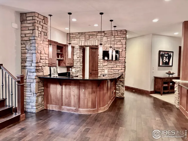 a view of kitchen with stainless steel appliances granite countertop a living room