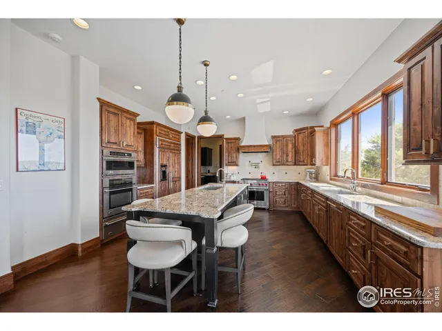 a large kitchen with a table and chairs