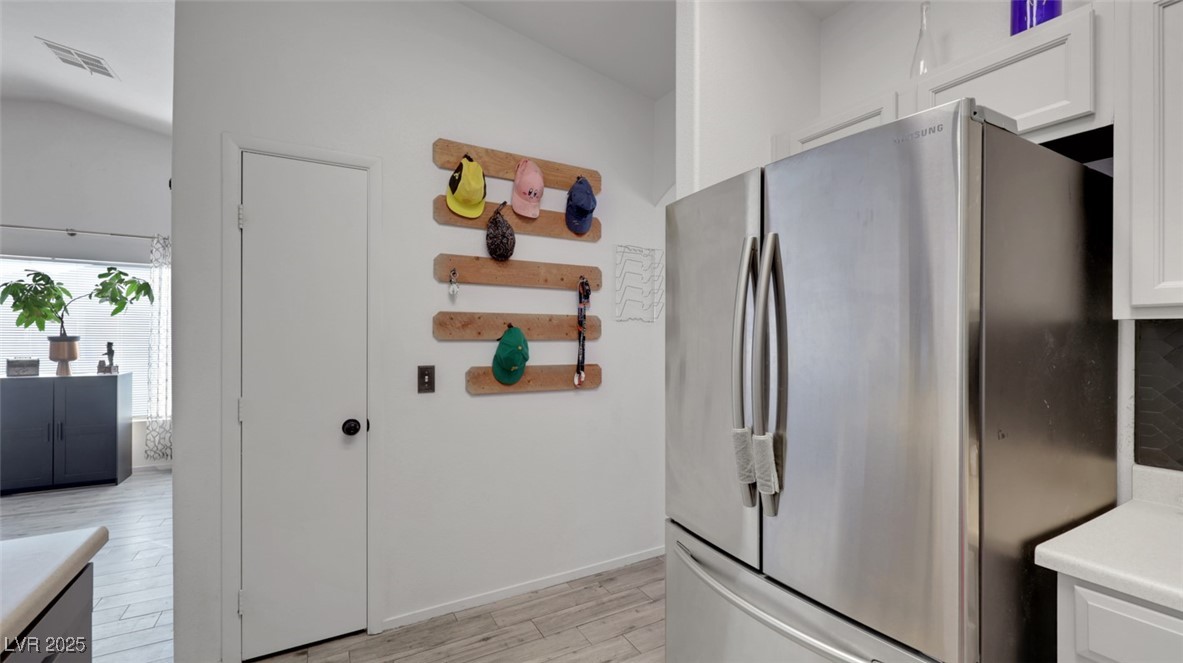 5940 High Steed Street, Unit 101 Henderson, NV 89011 - Photo 13 of 30 Kitchen with refrigerator, light countertops, light wood-look flooring, and light cabinetry
