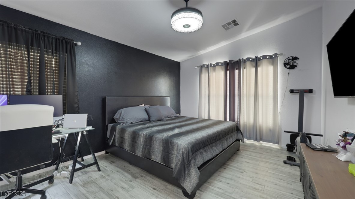 5940 High Steed Street, Unit 101 Henderson, NV 89011 - Photo 14 of 30 Bedroom with ceiling fan/light, wood-look floors