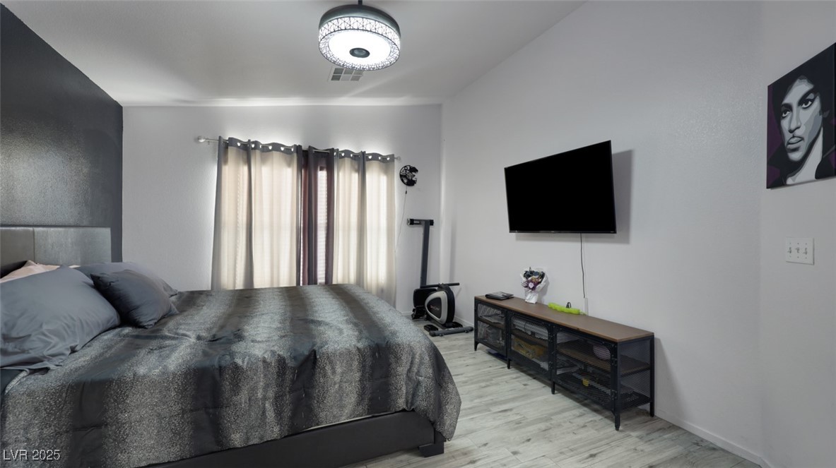 5940 High Steed Street, Unit 101 Henderson, NV 89011 - Photo 15 of 30 Bedroom featuring ceiling fan/light wood-look floors