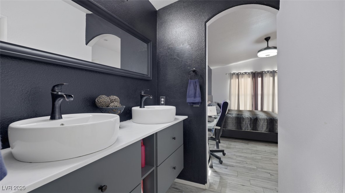 5940 High Steed Street, Unit 101 Henderson, NV 89011 - Photo 20 of 30 Ensuite bathroom featuring double vanity, and light wood-look flooring