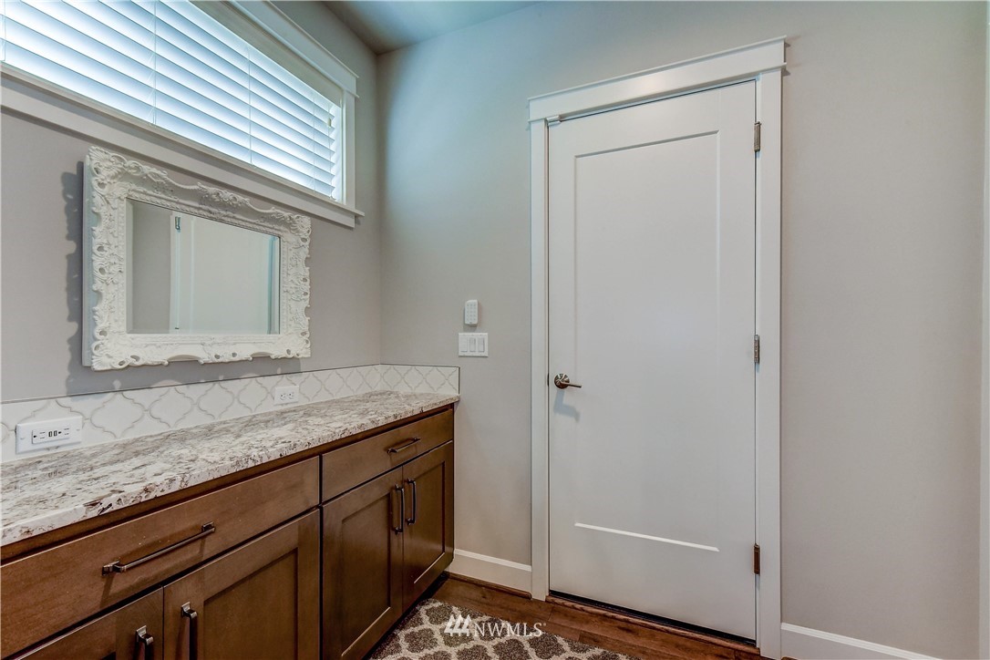 1607 233rd Street Southeast Bothell, WA 98021 - Photo 12 of 36 a bathroom with a granite countertop sink and a mirror