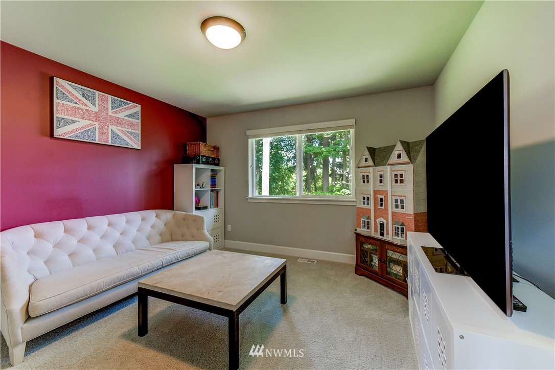 1607 233rd Street Southeast Bothell, WA 98021 - Photo 27 of 36 a living room with furniture and a flat screen tv