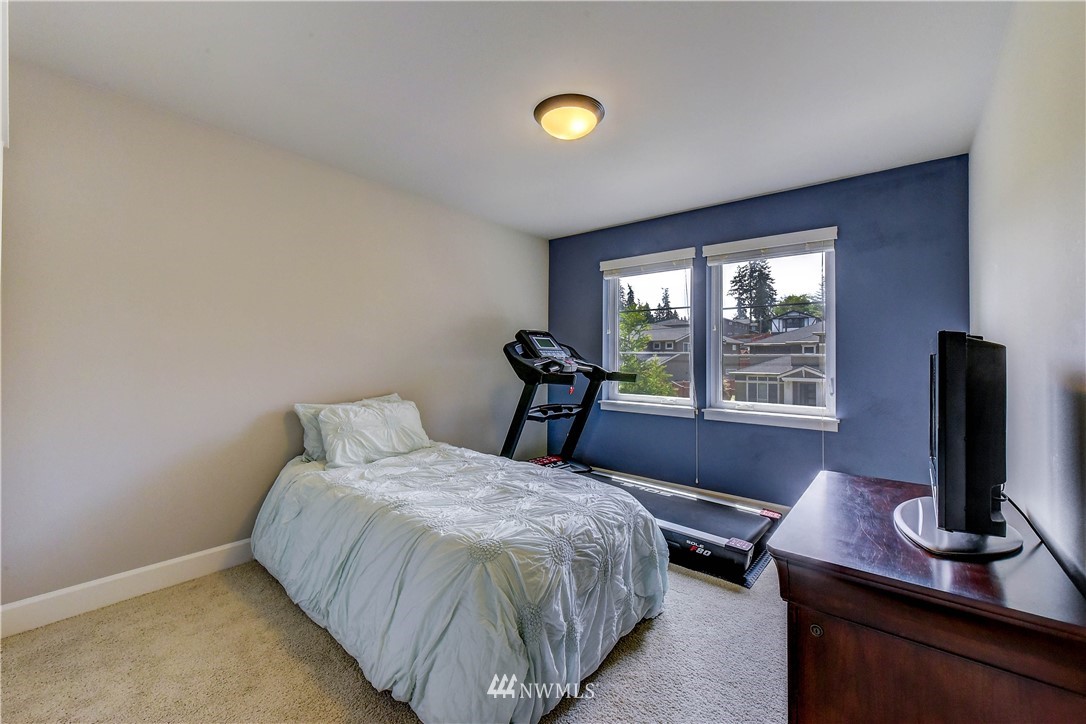 1607 233rd Street Southeast Bothell, WA 98021 - Photo 28 of 36 a bedroom with bed and a flat tv screen on a dresser