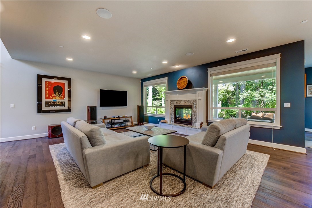 1607 233rd Street Southeast Bothell, WA 98021 - Photo 6 of 36 a living room with furniture a flat screen tv and a fireplace