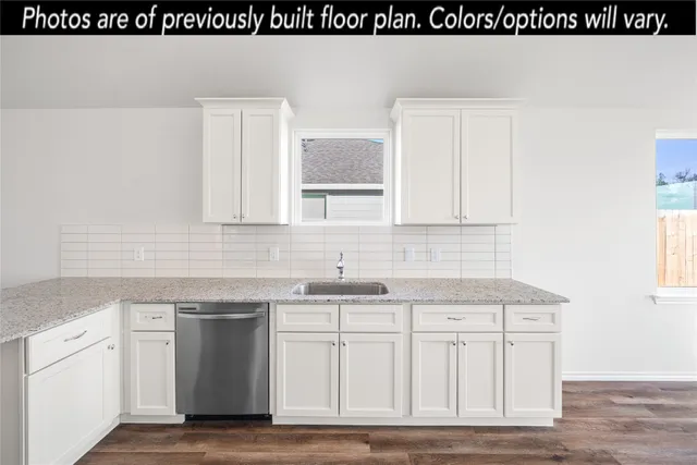 a kitchen with white cabinets