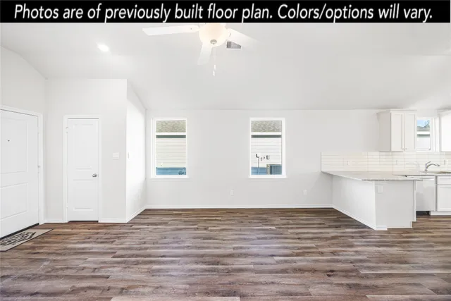 a view of a kitchen with wooden floor