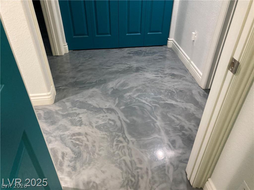 9050 West Warm Springs Road, Unit 1027 Las Vegas, NV 89148 - Photo 15 of 44 Stylish resin flooring adds a unique touch to this inviting hallway.