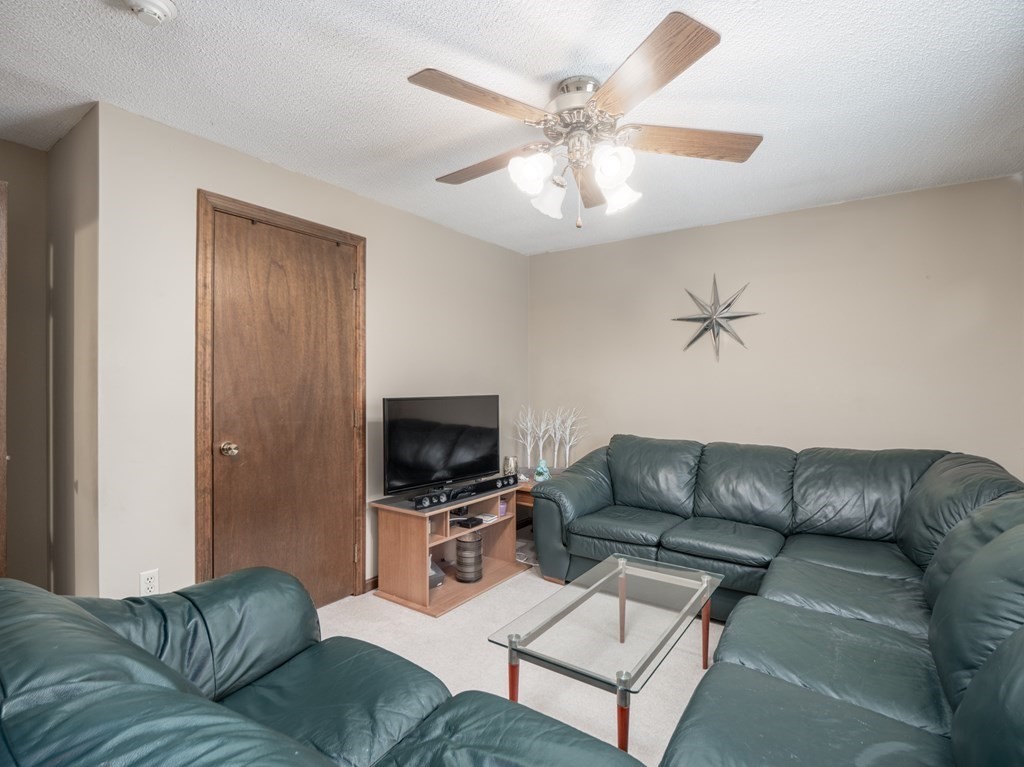 21 Partridge Road Dracut, MA 01826 - Photo 27 of 42 a living room with furniture and a flat screen tv