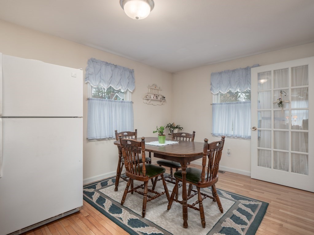 21 Partridge Road Dracut, MA 01826 - Photo 32 of 42 a view of a dining room with furniture and wooden floor