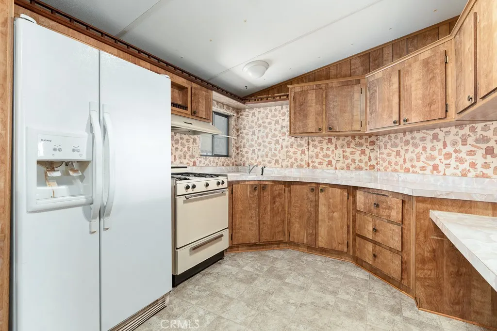 1700 South State Street, Unit 76 Hemet, CA 92543 - Photo 11 of 36 a kitchen with stainless steel appliances granite countertop a stove a sink and a refrigerator