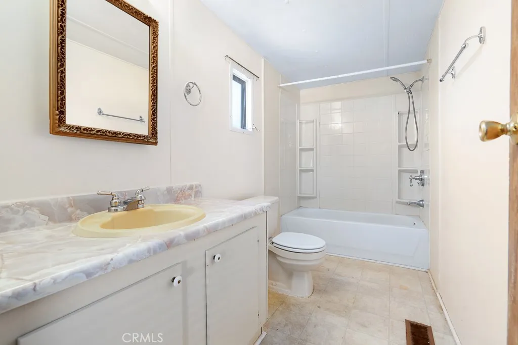 1700 South State Street, Unit 76 Hemet, CA 92543 - Photo 27 of 36 a bathroom with a granite countertop sink toilet and shower