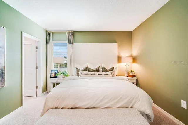 a bedroom with a bed and wall painting