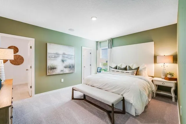 a bathroom with a granite countertop double vanity sink and a mirror