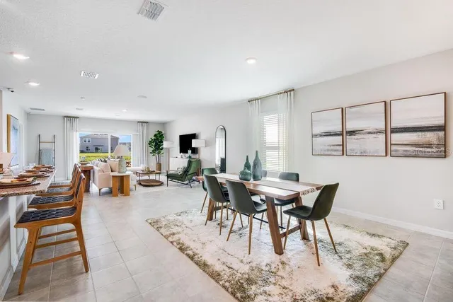 a view of a kitchen with kitchen island dining table and chairs