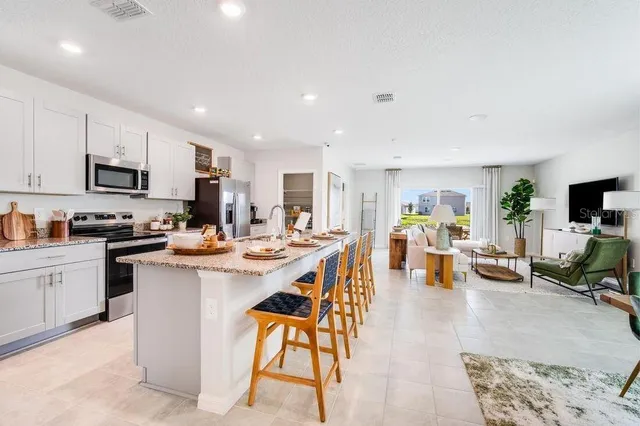 a kitchen with cabinets and stainless steel appliances