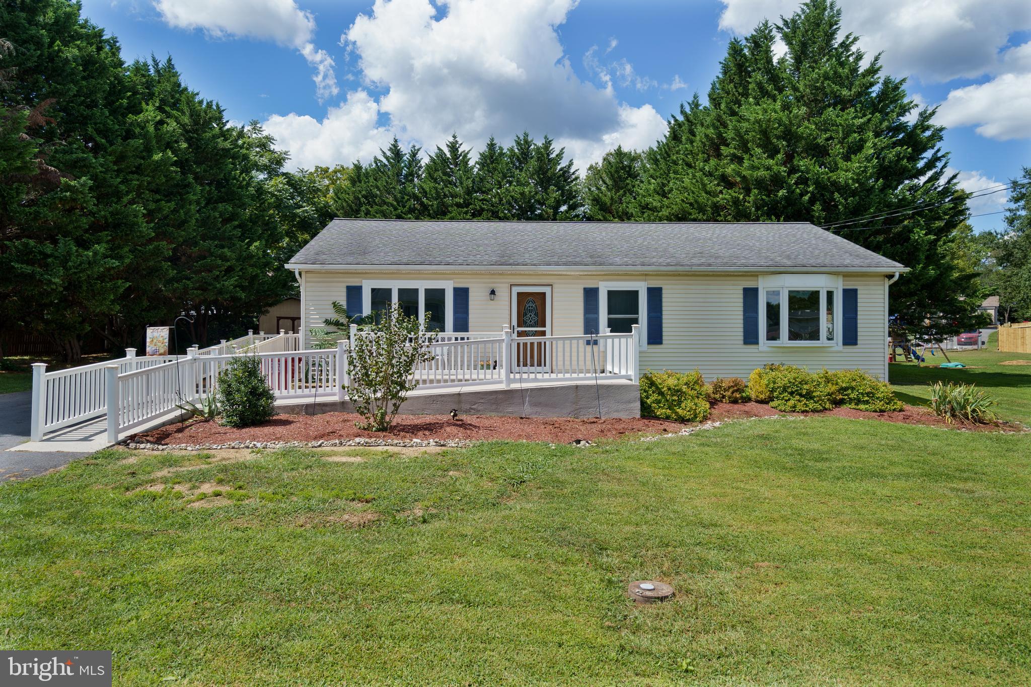 a front view of house with yard and green space