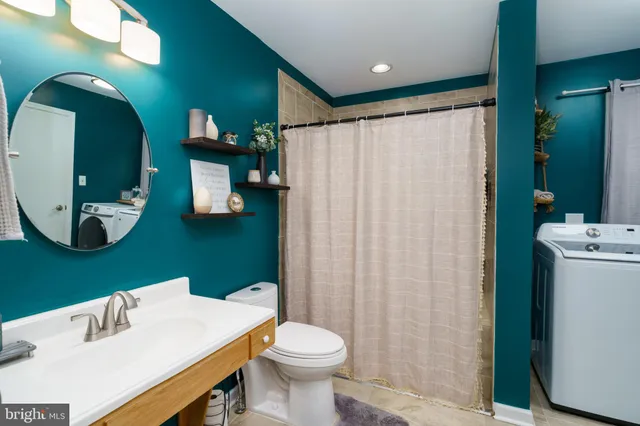 a bathroom with a sink a toilet and mirror