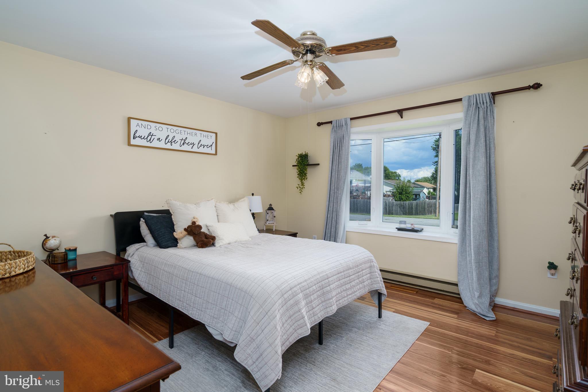 472 Upshur Drive Inwood, WV 25428 - Photo 15 of 26 a bedroom with a bed and a large window