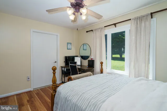 a bedroom with a bed window and a chandelier