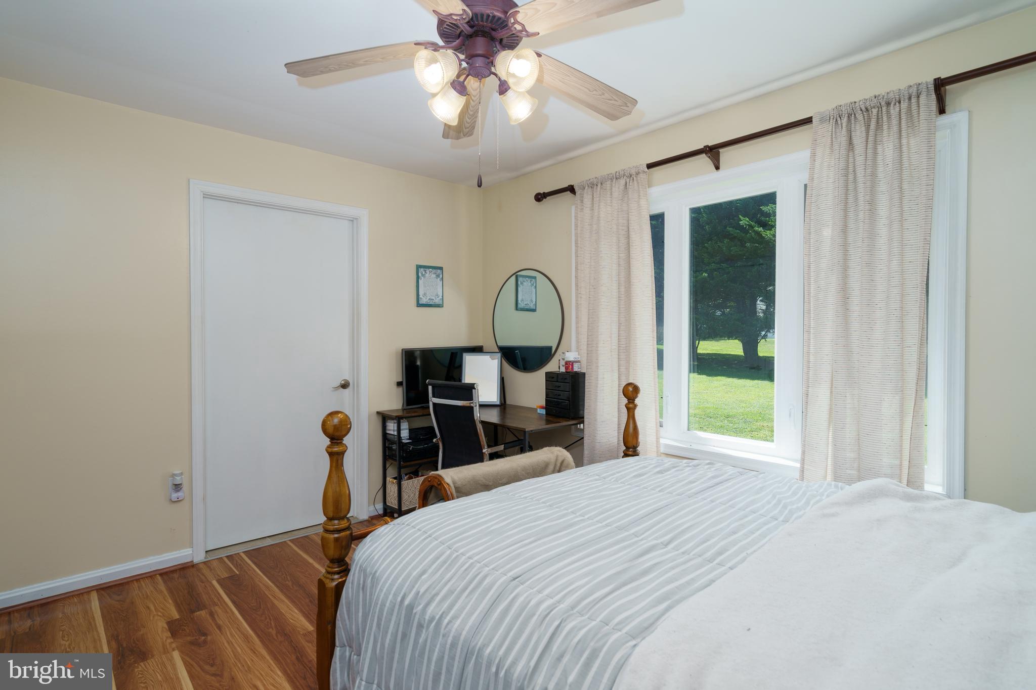 472 Upshur Drive Inwood, WV 25428 - Photo 18 of 26 a bedroom with a bed window and a chandelier