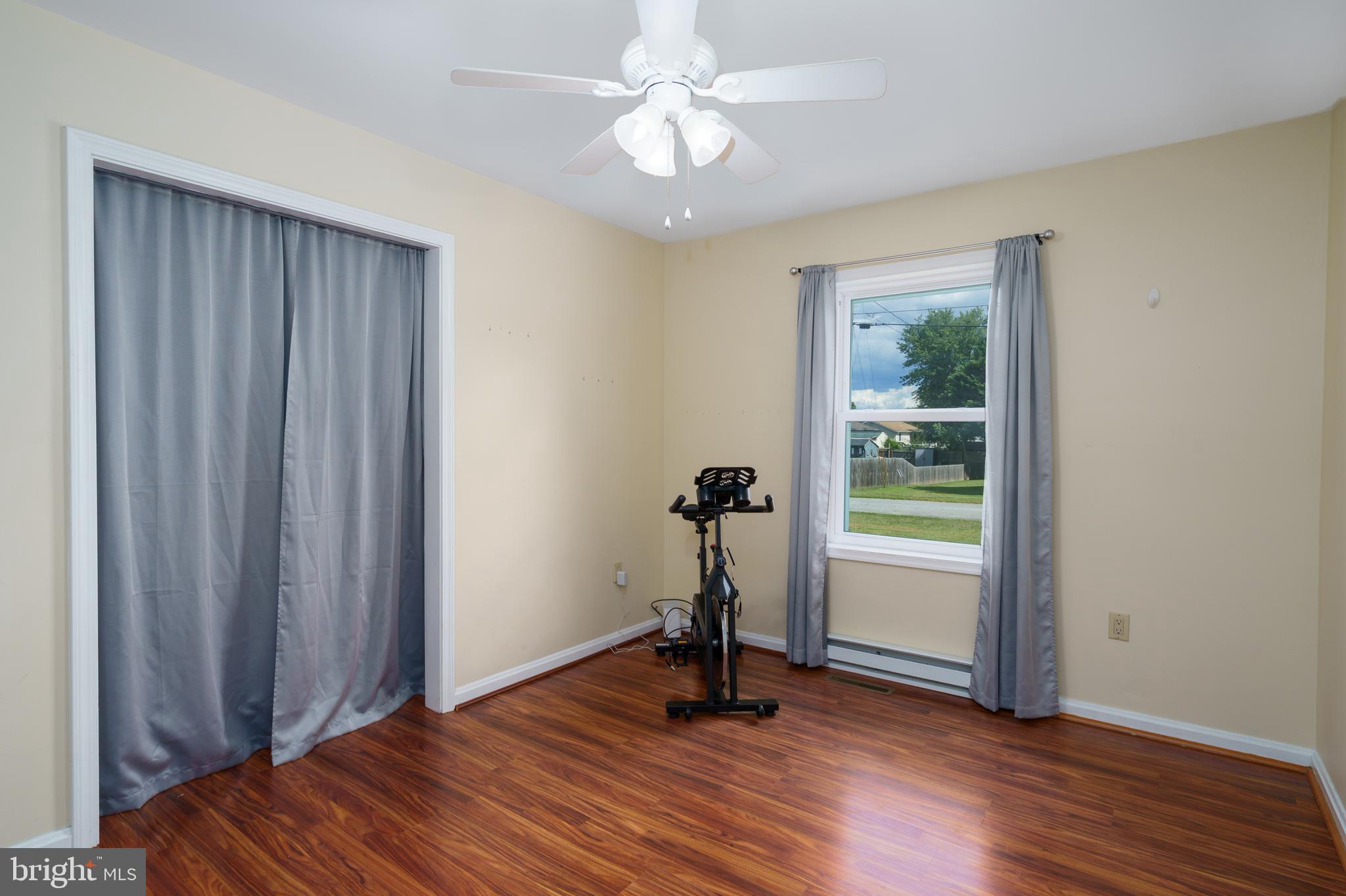 472 Upshur Drive Inwood, WV 25428 - Photo 19 of 26 a view of a room with wooden floor staircase and a ceiling fan