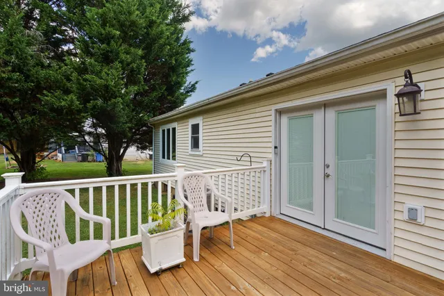 a view of deck with a chair and wooden floor