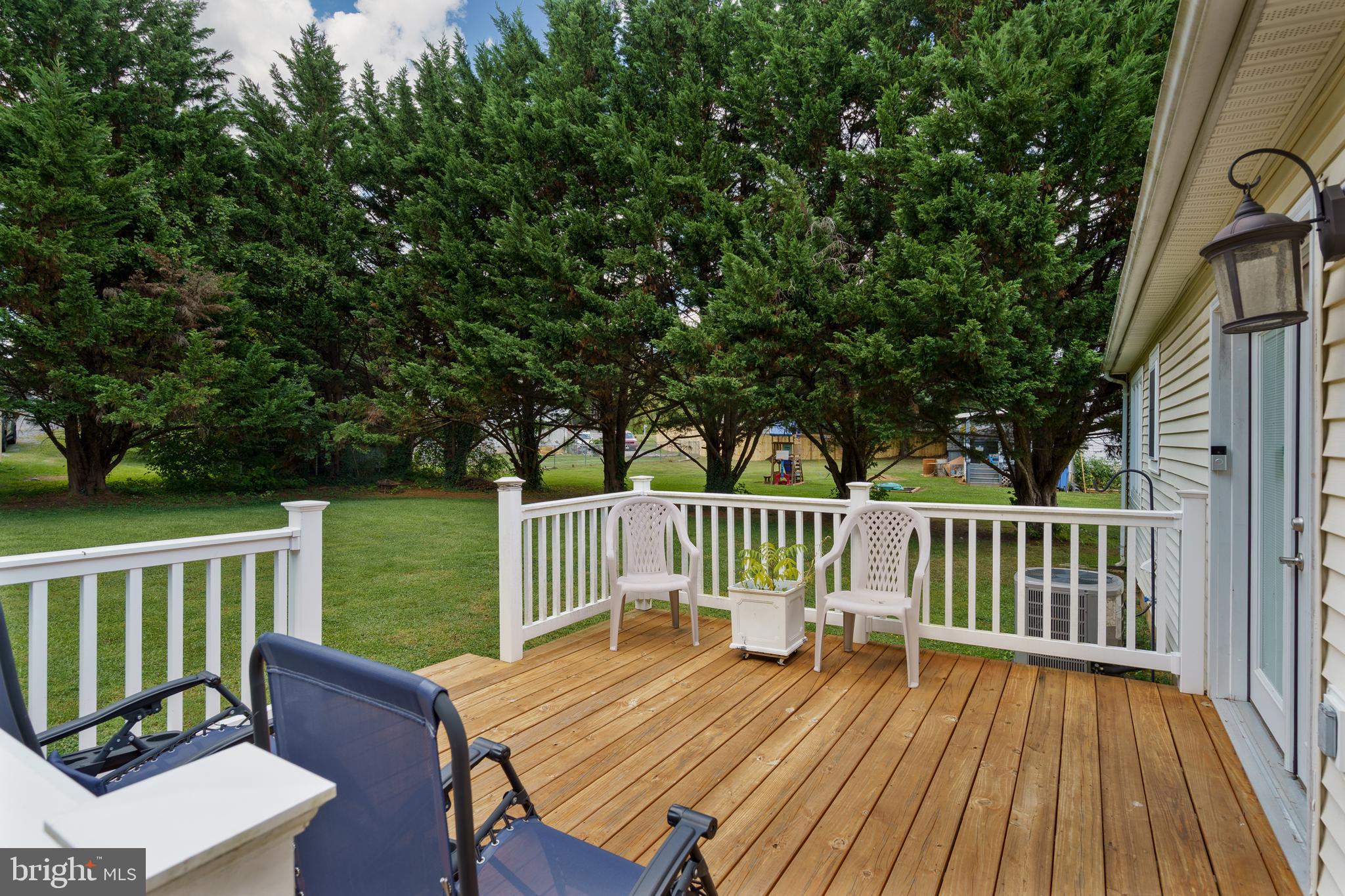 472 Upshur Drive Inwood, WV 25428 - Photo 20 of 26 a view of a wooden deck with a bench