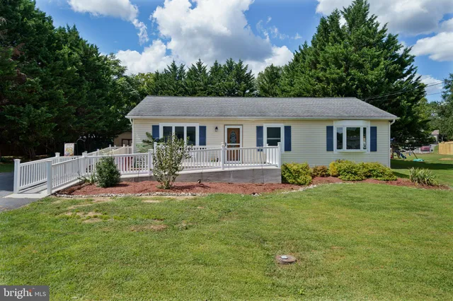 a front view of house with yard and green space