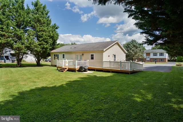 a view of house with backyard and garden