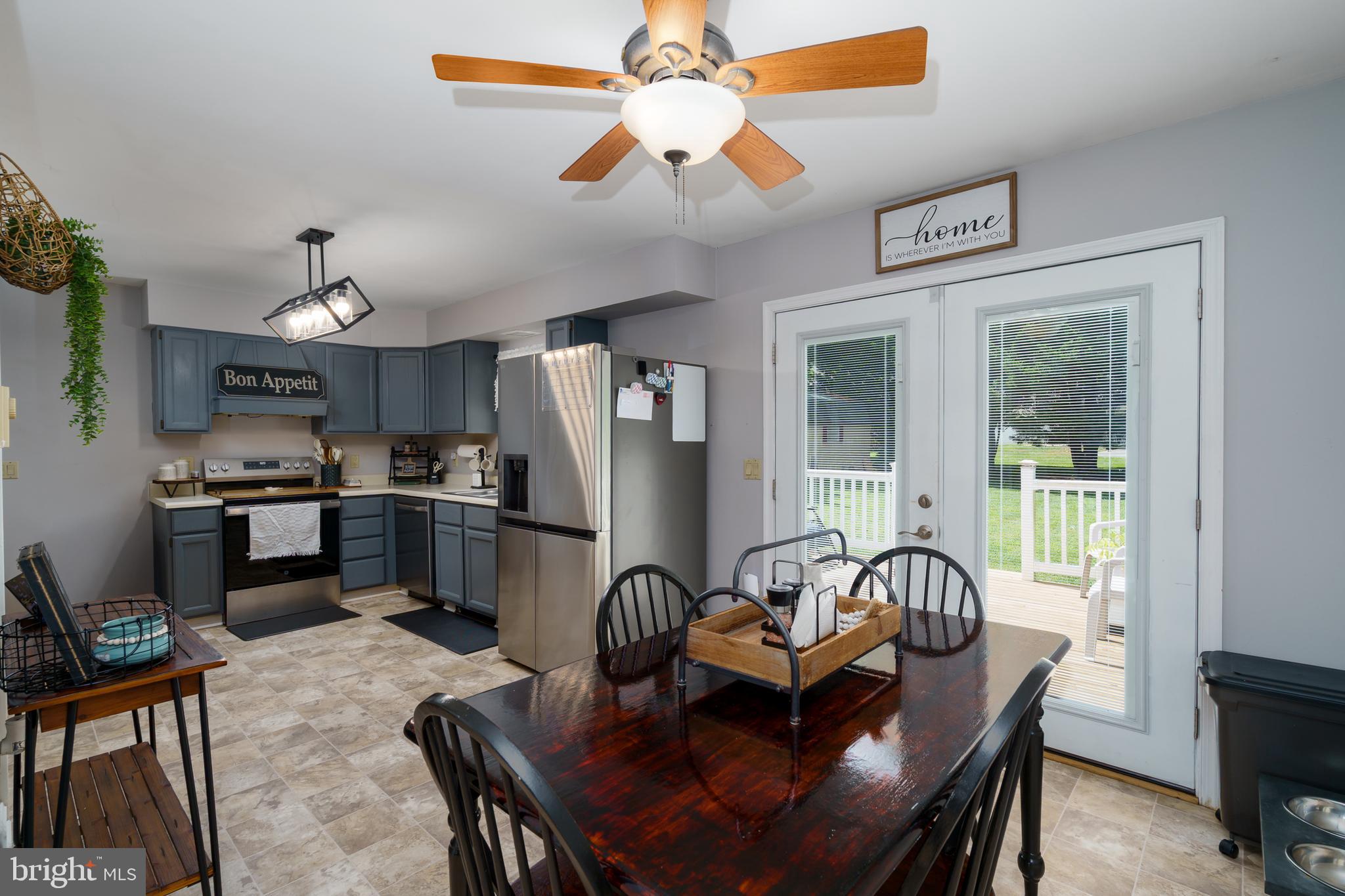 472 Upshur Drive Inwood, WV 25428 - Photo 6 of 26 a dining room with stainless steel appliances kitchen island granite countertop furniture and a chandelier