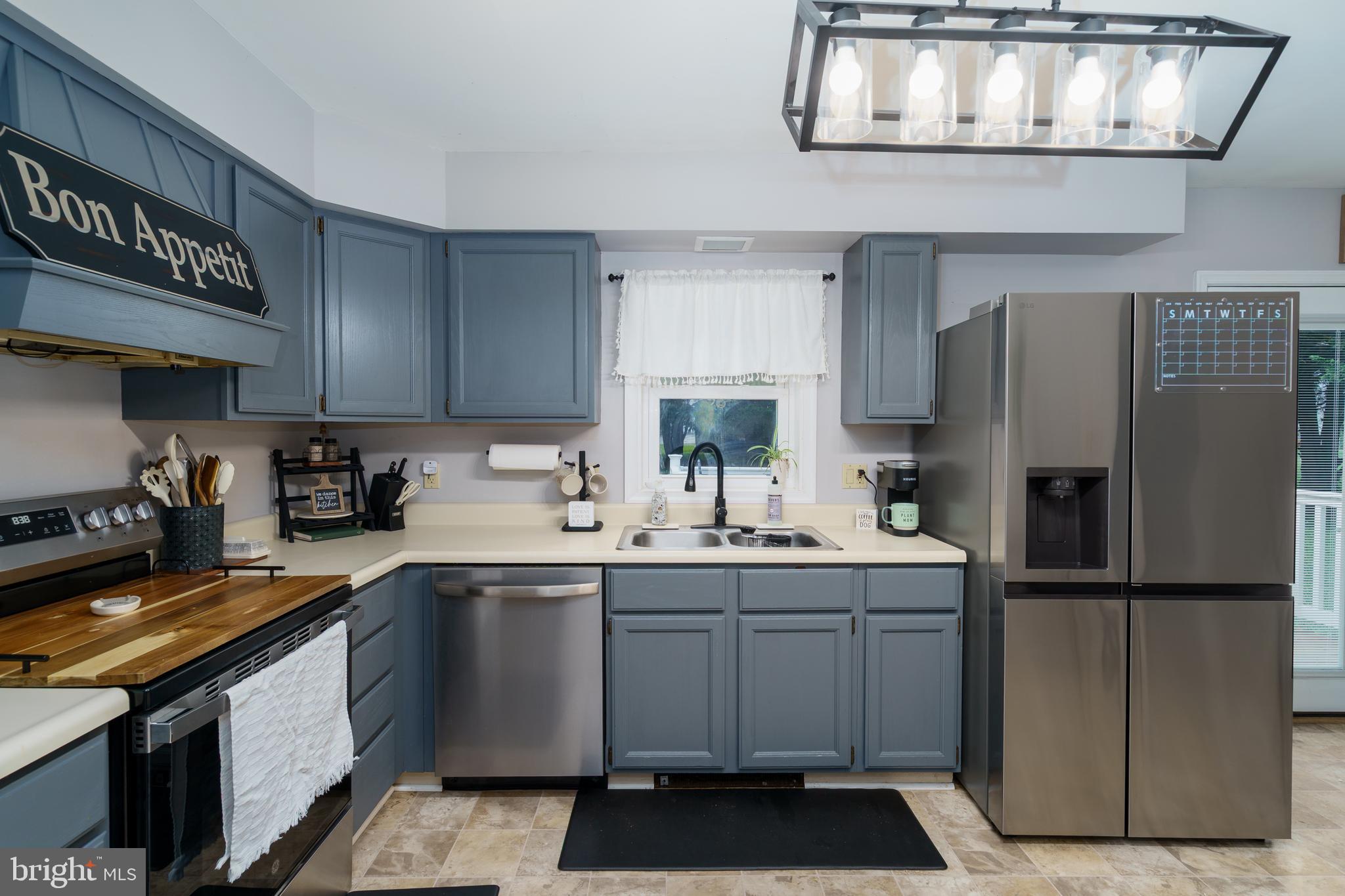 472 Upshur Drive Inwood, WV 25428 - Photo 10 of 26 a kitchen with a sink stainless steel appliances and cabinets