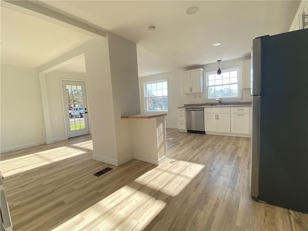 380 Vanadium Road Pittsburgh, PA 15243 - Photo 11 of 23 a kitchen with cabinets and wooden floor