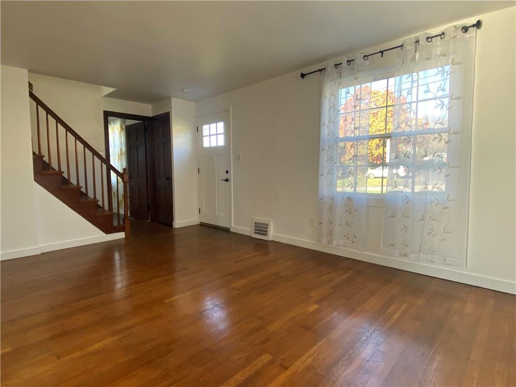 380 Vanadium Road Pittsburgh, PA 15243 - Photo 5 of 23 a view of an empty room with wooden floor and a window