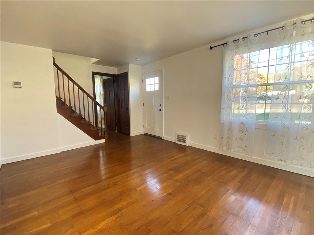 380 Vanadium Road Pittsburgh, PA 15243 - Photo 7 of 23 a view of an empty room with wooden floor and a window
