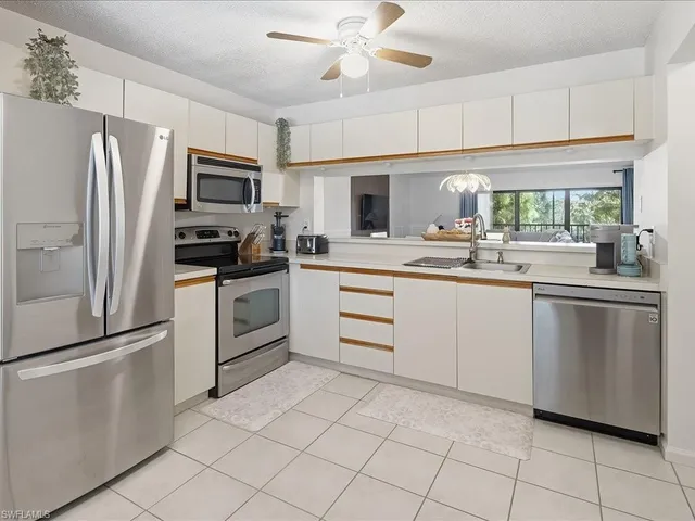 a bedroom with bed and a chandelier