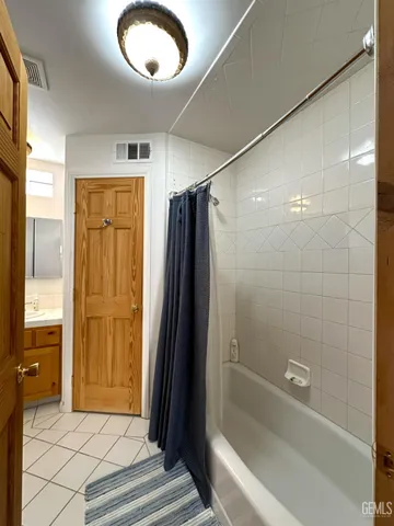 a bathroom with a granite countertop toilet sink and mirror