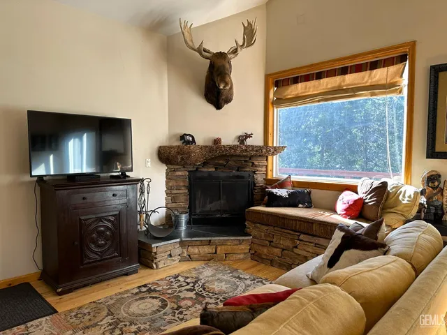 a living room with furniture a flat screen tv and a fireplace
