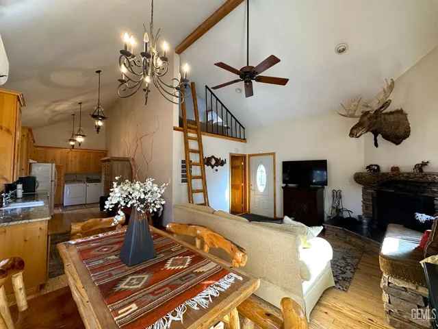 a living room with furniture a chandelier and a dining room