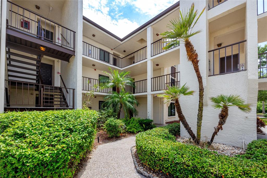 2207 Belleair Road, Unit B30 Clearwater, FL 33764 - Photo 1 of 39 a front view of a multi story building with yard