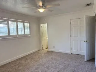 an empty room with windows and closet