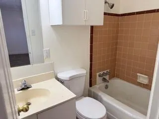 a bathroom with a sink a toilet and bathtub