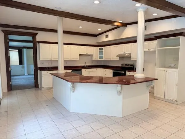a kitchen with stainless steel appliances granite countertop a sink and a stove
