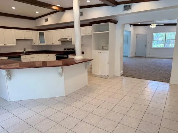 a kitchen with stainless steel appliances a sink stove and cabinets