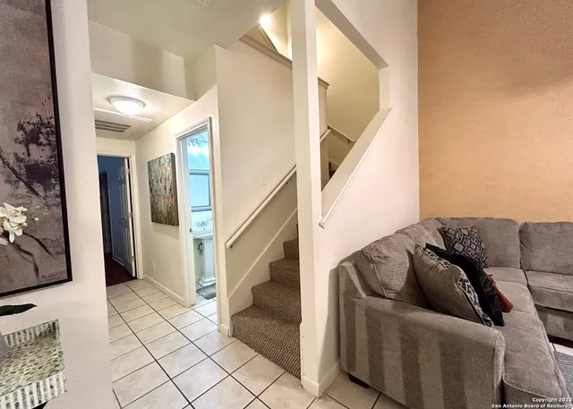 a living room with furniture and a rug