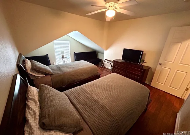 a bedroom with two beds and a chandelier
