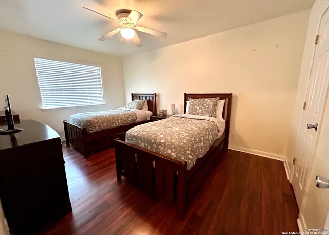 a bedroom with two beds and a chandelier
